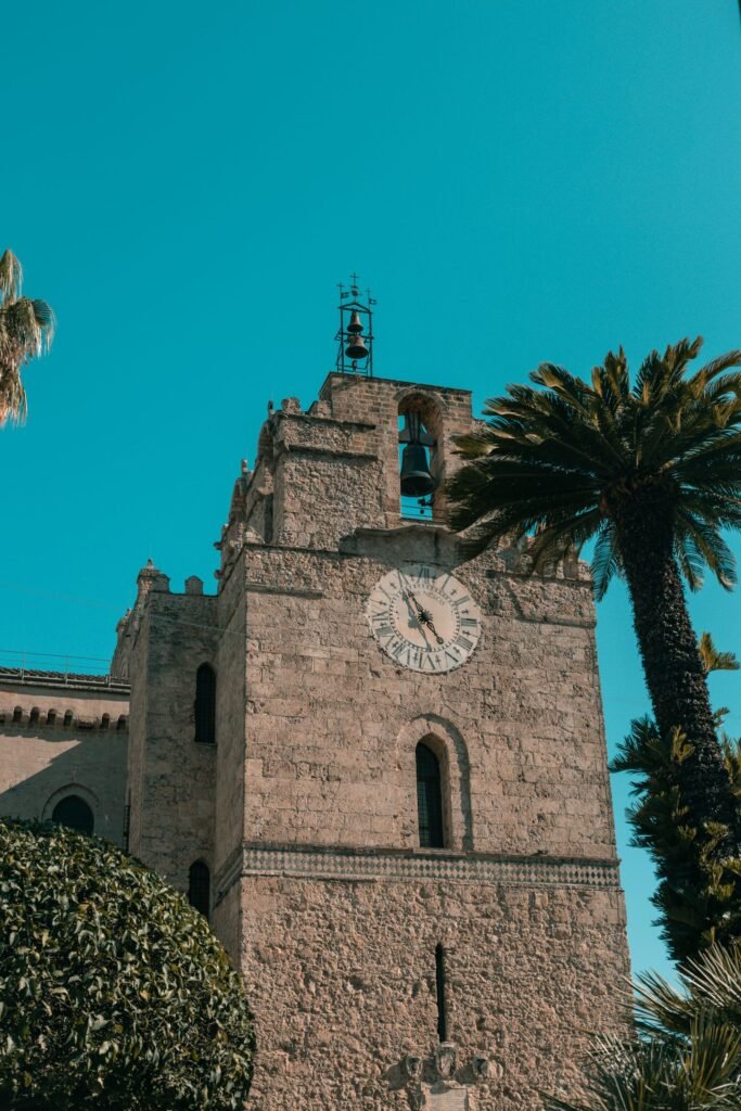 The facade of Monreale Cathedral in Sicily, its two square towers flanking the arched entrance.