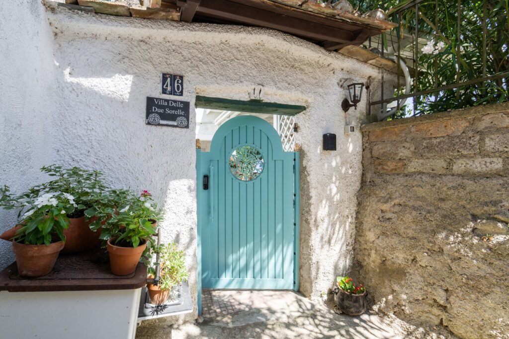 Blue arched door with potted plants, Two Sisters Villa